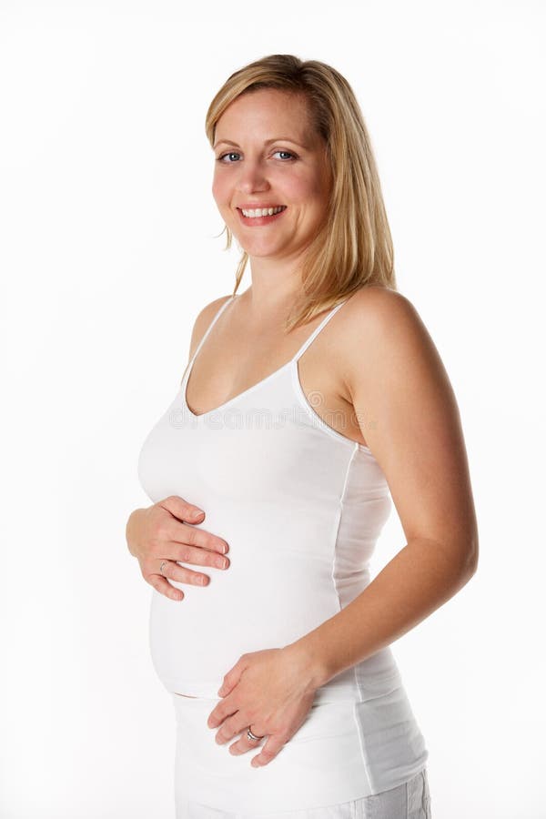 Studio Portrait Of 4 months pregnant Woman Wearing White