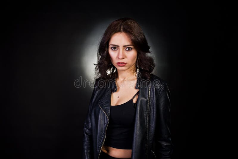 Studio portrait of sexy brunette girl in black leather jacket