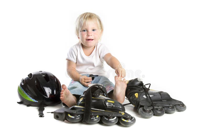 Studio shot of cute toddler with rollerskates