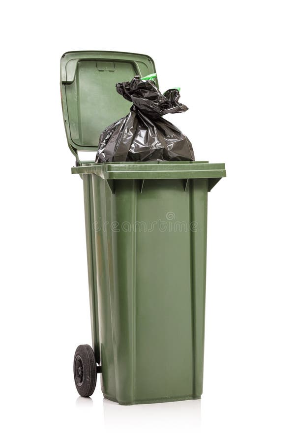 Studio shot of a green garbage bin with a plastic bag inside royalty free stock photos