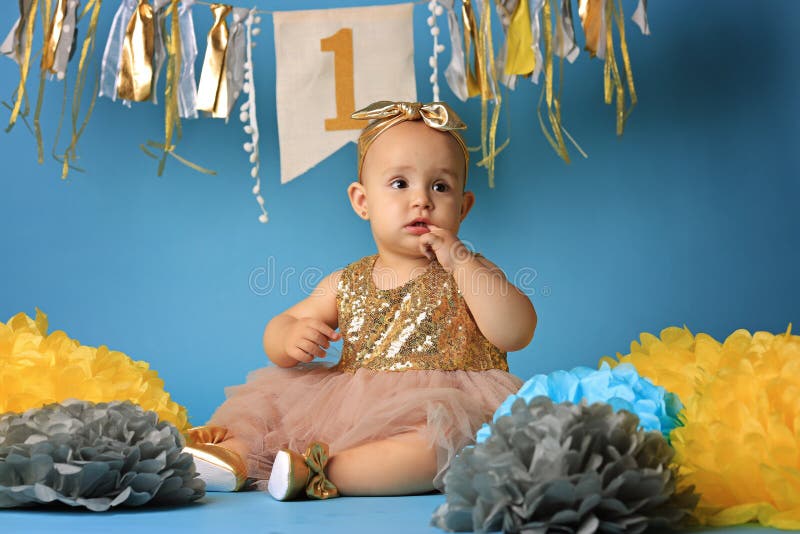 Studio shot, little girl on blue background in beautiful festive dress royalty free stock images Studio shot, little girl on blue background in beautiful festive dress royalty free stock images