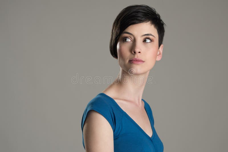 Studio shot of short hair beauty model looking back over the shoulder with copyspace