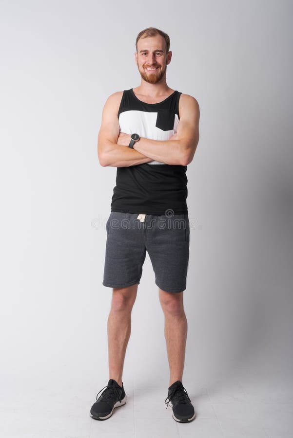 Studio shot of young bearded man against white background. Studio shot of young bearded man against white background