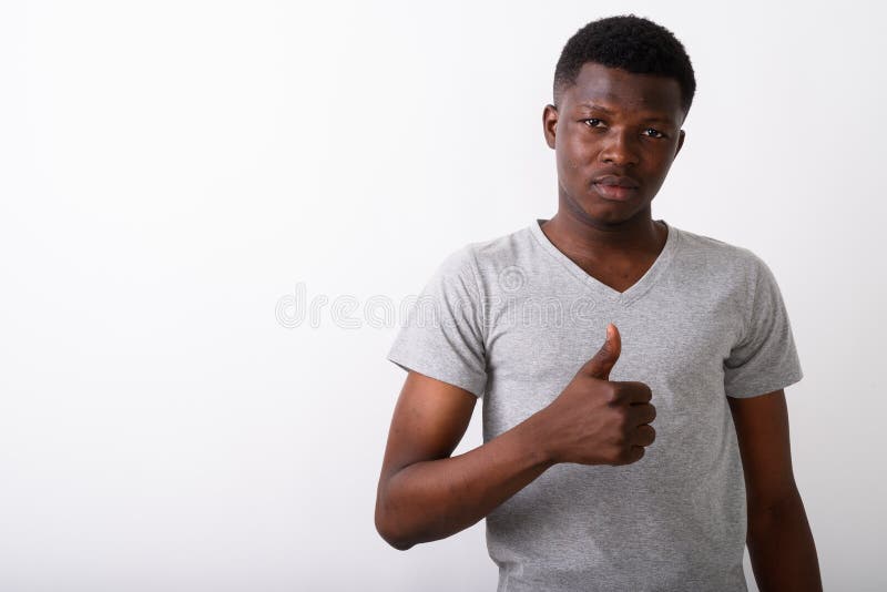 Studio Shot of Young Black African Man Giving Thumb Up Against W Stock ...