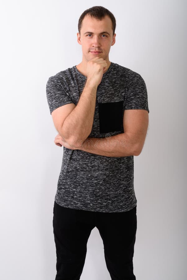 Studio Shot of Young Muscular Man Standing while Thinking Agains Stock ...