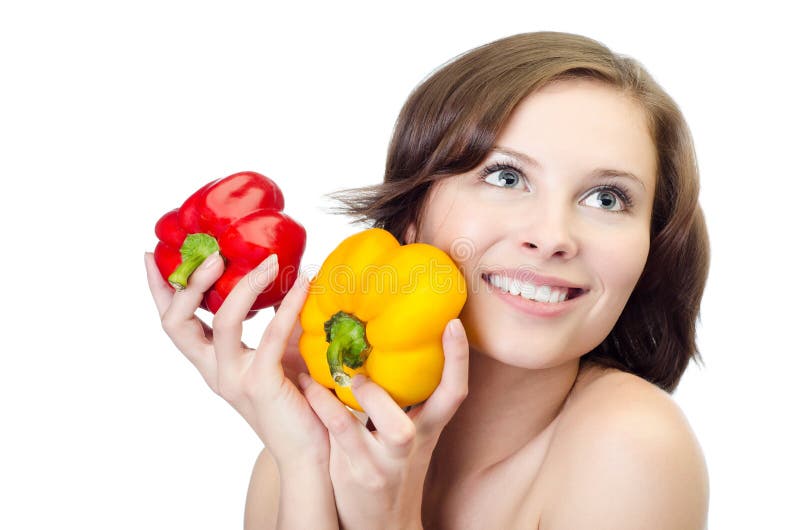 Studio shot of a young woman with two peppers