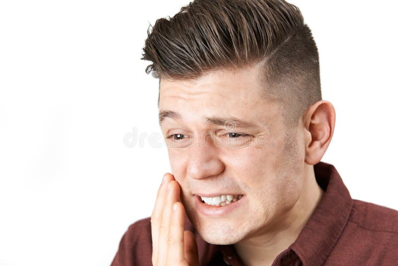 Studio van de Jonge Mens wordt geschoten die met Tandpijn lijden die stock afbeelding Studio van de Jonge Mens wordt geschoten die met Tandpijn lijden die stock afbeelding