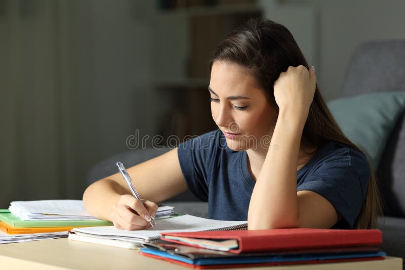 Studious Student Learning Taking Notes in the Night Stock Image
