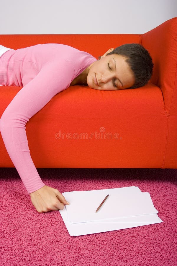 Young woman takes a break from studying. Vertical portrait, with focus on face and notes on floor. Young woman takes a break from studying. Vertical portrait, with focus on face and notes on floor.