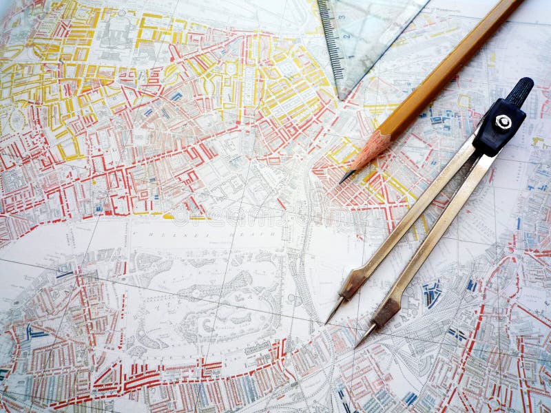 A conceptual image of the study of an old city planning map. Taken with compass divider, pencil and set square. Horizontal color format. Nobody in picture. A conceptual image of the study of an old city planning map. Taken with compass divider, pencil and set square. Horizontal color format. Nobody in picture.