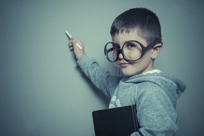 Study, young student writing on a blackboard school with a book