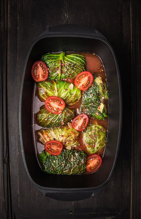 Stuffed cabbage leaf with with tomato sauce in cast iron pan