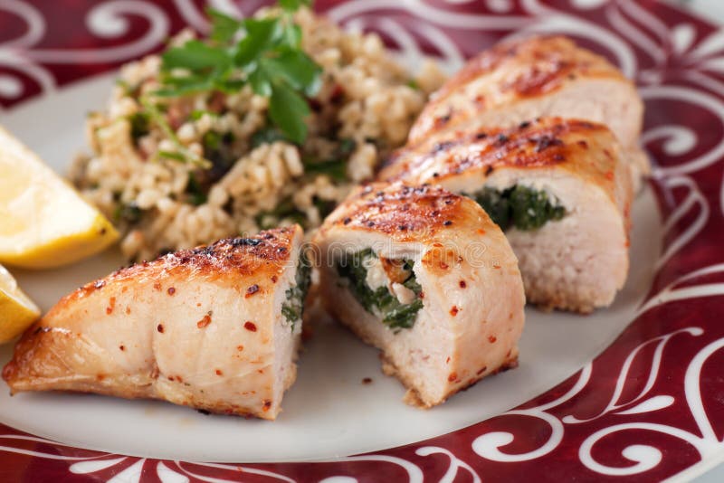 Grilled chicken breast stuffed with spinach, served with bulgur wheat salad. Grilled chicken breast stuffed with spinach, served with bulgur wheat salad