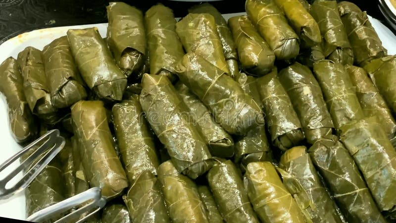 Stuffed grape leaves on the counter of the store.