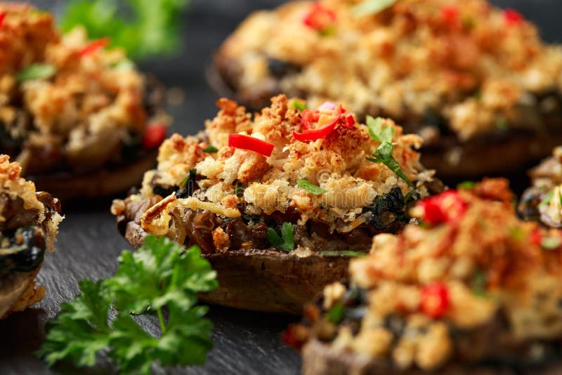 Stuffed Mushrooms with Spinach, Bread Crumbs and Cheese on Stone Board