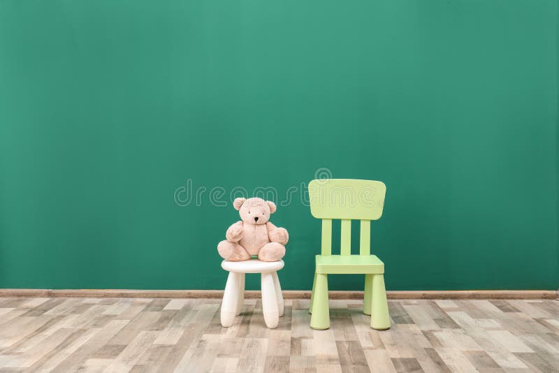 Stuffed Toy Bear on Stool and Chair in Child Room. Stock Image Image
