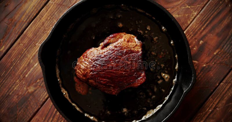 Stuk van vlees in olie op pan wordt gebraden die