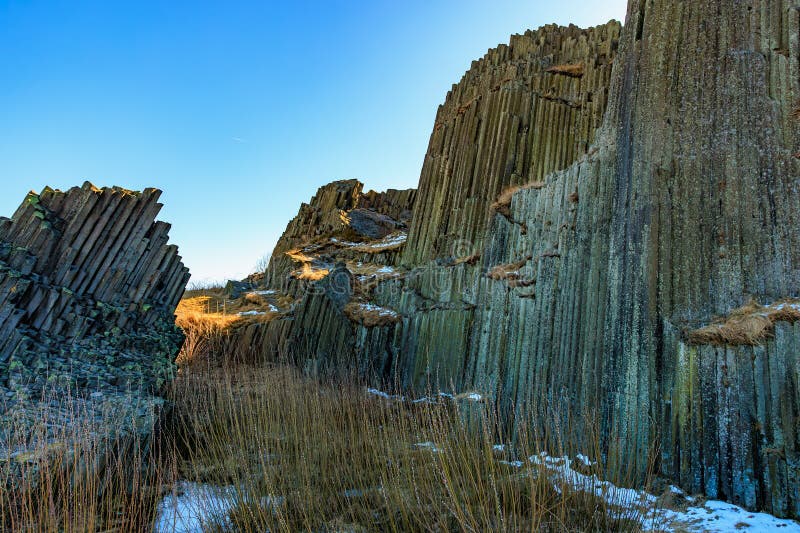 Stunning basalt columns under clear blue sky in scenic natural landscape royalty free stock images
