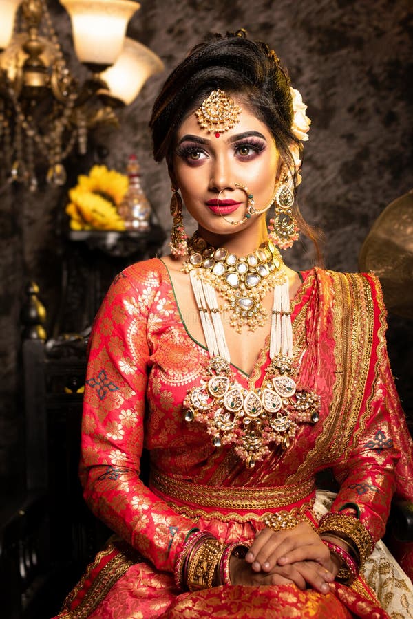 Magnificent Young Indian Bride in Luxurious Bridal Costume with Makeup and Heavy Jewellery is Sitting in a Chair Stock Photo - Image of indian, hair: 212508344 Magnificent Young Indian Bride in Luxurious Bridal Costume with Makeup and Heavy Jewellery is Sitting in a Chair Stock Photo - Image of indian, hair: 212508344