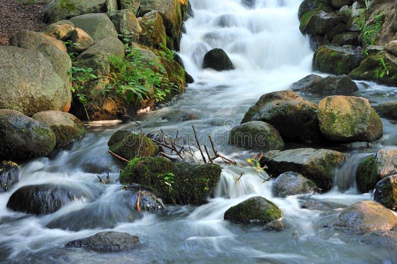 Stunning landscape of a small waterfall cascading stock images