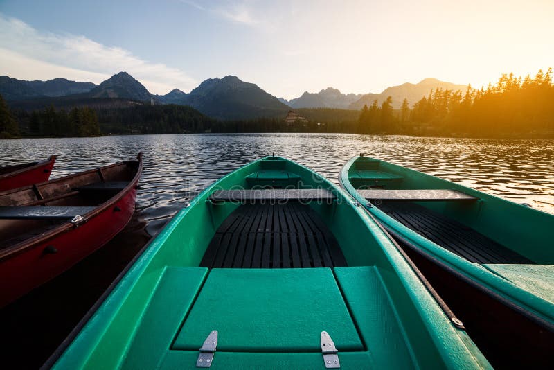 Ohromující horské jezero s barevným dřevěným člunem.