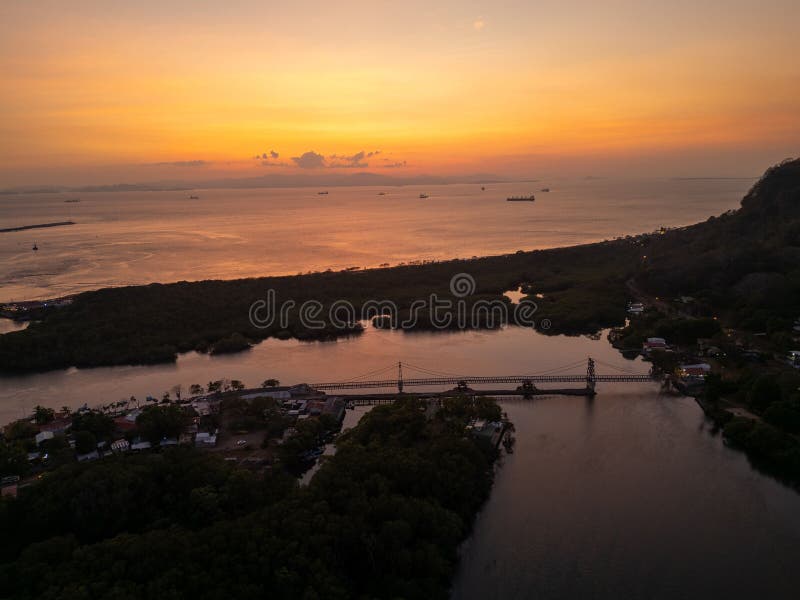 Sunset over coastal landscape with bridge and ships. stock photos