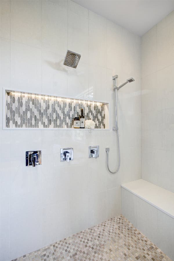 Stunning walk-in shower with white tile surround.