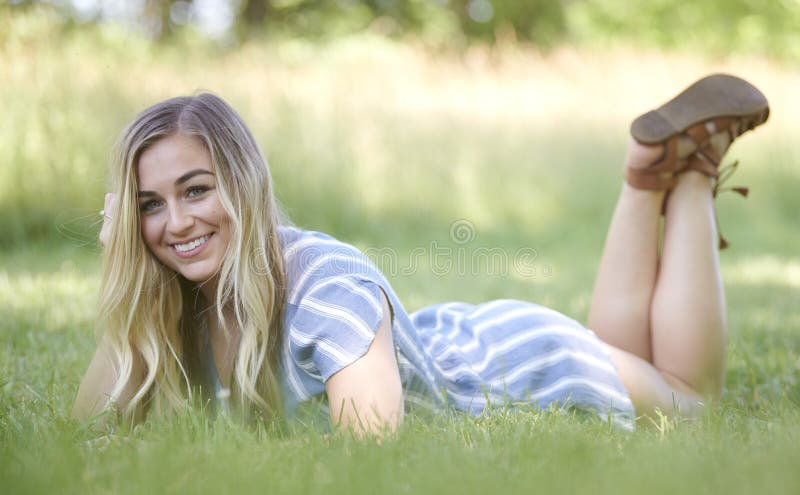 3 pretty blonde girls frolicking on the grass