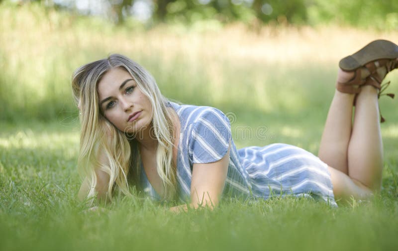 3 pretty blonde girls frolicking on the grass