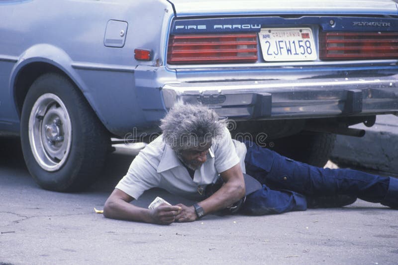 Fallen homeless man laying on city street, Los Angeles, California. Fallen homeless man laying on city street, Los Angeles, California