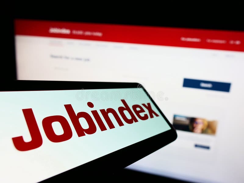 Mobile phone with logo of Danish recruitment platform company Jobindex AS on screen in front of business website.