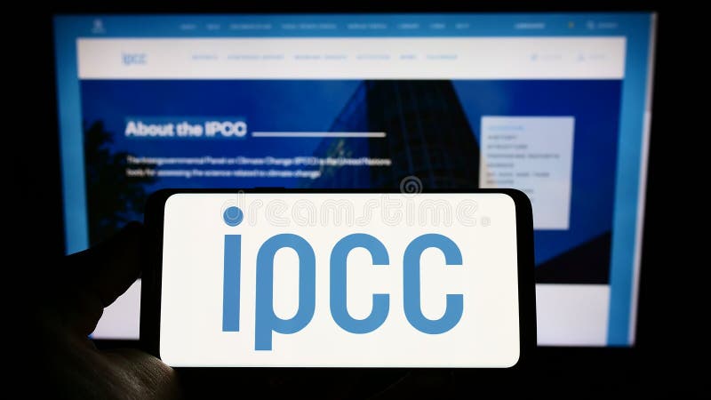 Person holding mobile phone with logo of Intergovernmental Panel on Climate Change (IPCC) on screen with web page. royalty free stock photo