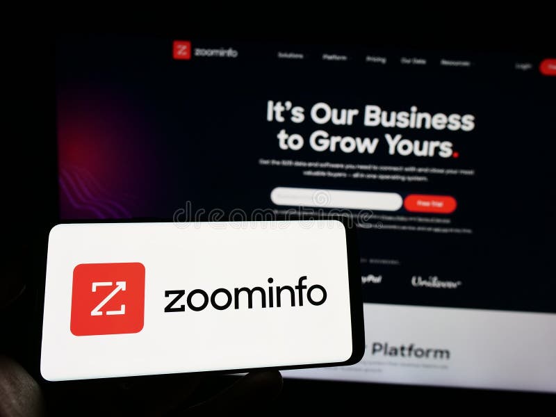 Person Holding Smartphone with Logo of US Software Company ZoomInfo