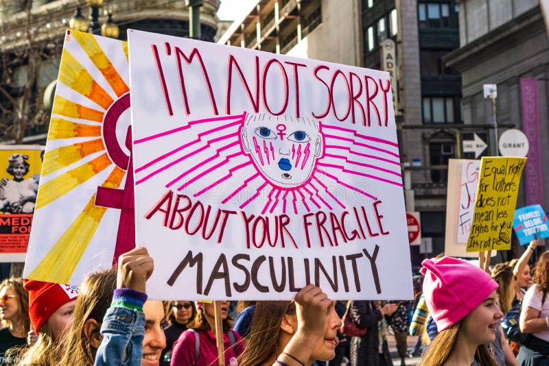 January 19, 2019 San Francisco / CA / USA - Participants to the Women`s March event hold sign referencing `toxic masculinity` while marching on Market street in downtown San Francisco. January 19, 2019 San Francisco / CA / USA - Participants to the Women`s March event hold sign referencing `toxic masculinity` while marching on Market street in downtown San Francisco