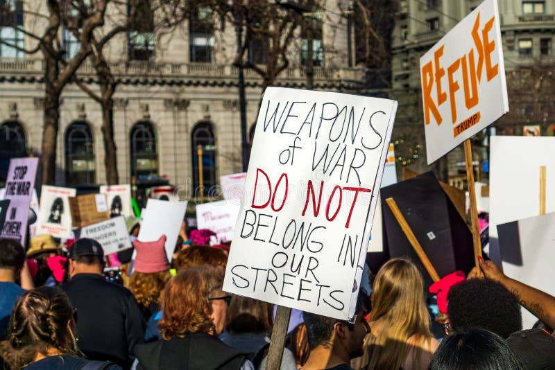 January 19, 2019 San Francisco / CA / USA - Participant to the Women`s March event holds sign referencing guns rights while marching on Market street in downtown San Francisco. January 19, 2019 San Francisco / CA / USA - Participant to the Women`s March event holds sign referencing guns rights while marching on Market street in downtown San Francisco