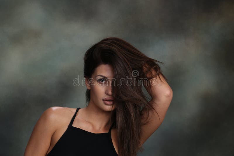 Attractive, sexy muscular brunette caucasian girl posing in studio on  background. Style, trends, fashion concept.