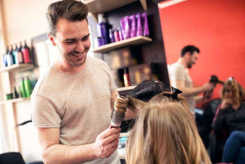Styling Hair by Male Hair Stylist at Beauty Salon Stock Photo - Image