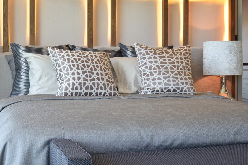 Stylish Bedroom Interior Design with Brown Pillows on Bed Stock Photo