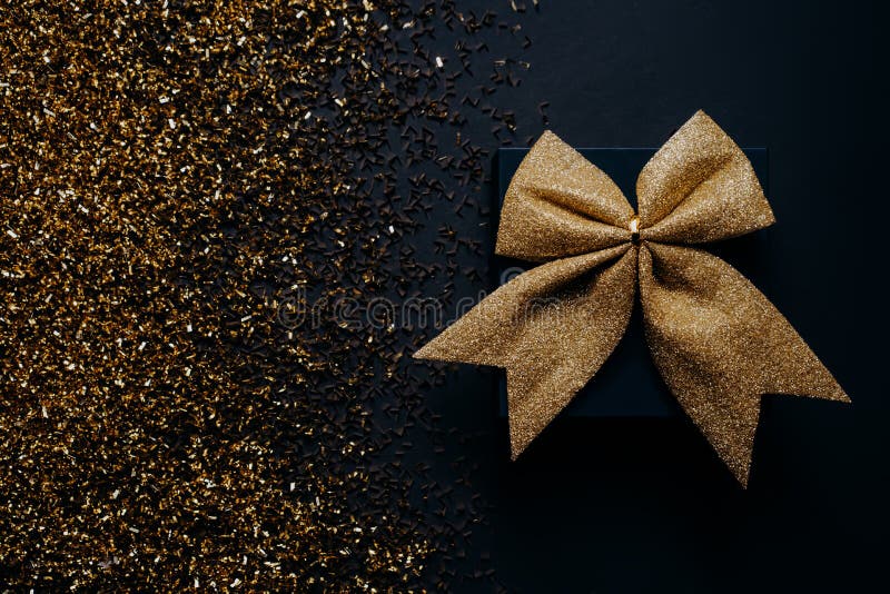 Stylish Black Gift Box with Bow on Golden Glitter Background. Isolated  Stock Image - Image of isolated, anniversary: 238794595