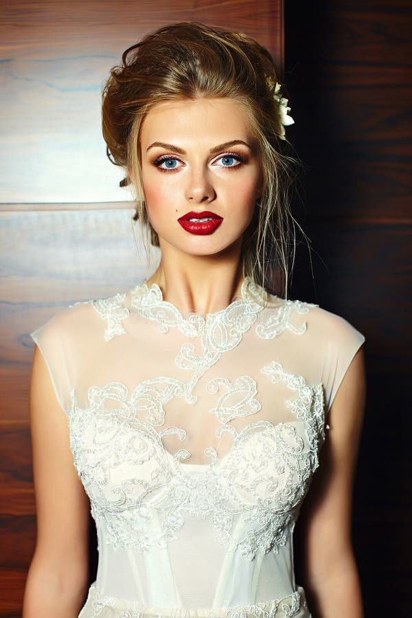 Stylish blond bride girl model in wedding dress