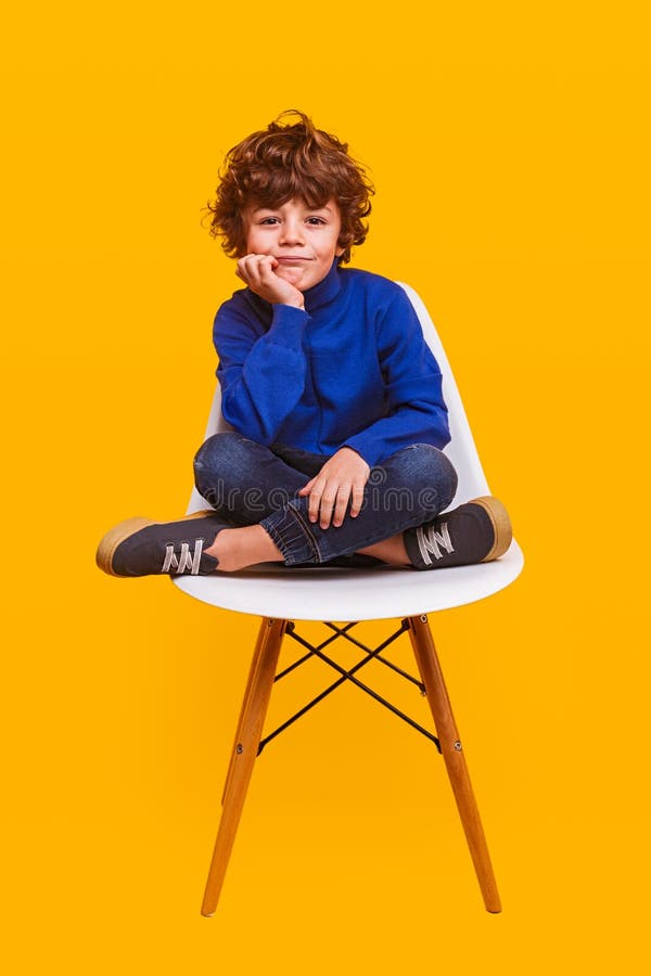 Stylish Boy Sitting on Chair Stock Image - Image of colorful, trendy ...