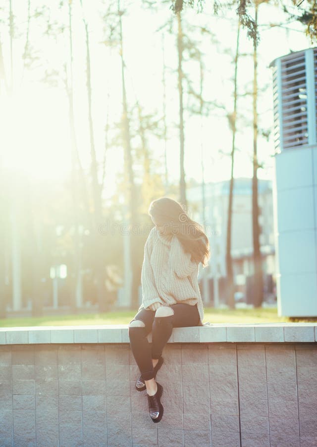 Stylish brunette woman sitting in city royalty free stock image Stylish brunette woman sitting in city royalty free stock image