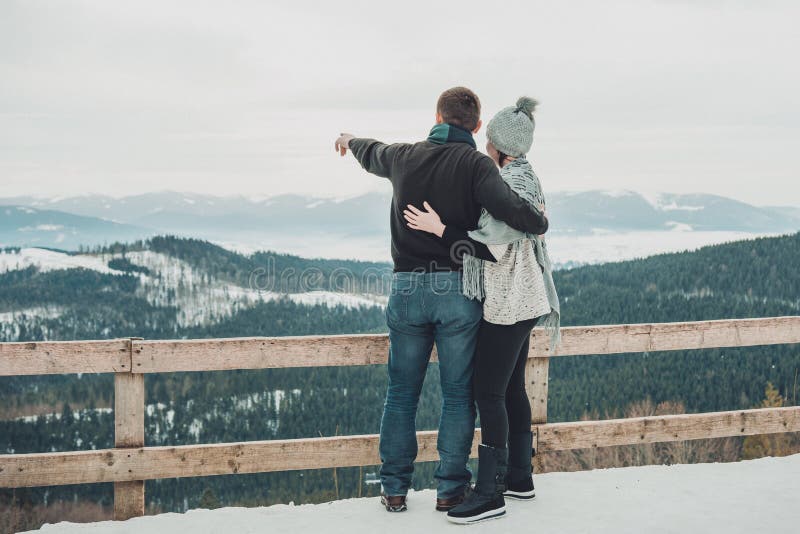 Loving couple embracing looking in the distance to the amazing landscape of the Carpathian mountains stock photos Loving couple embracing looking in the distance to the amazing landscape of the Carpathian mountains stock photos