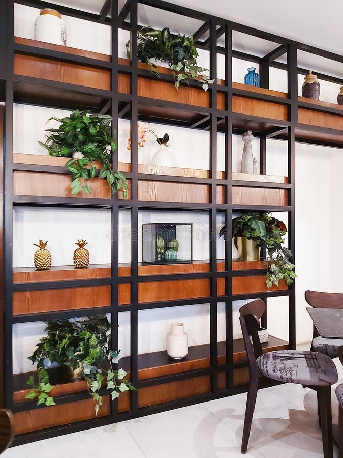 Stylish and cozy rack with shelves, decorating with various items. Cafe or living room interior. Lifestyle and decoration concept royalty free stock images Stylish and cozy rack with shelves, decorating with various items. Cafe or living room interior. Lifestyle and decoration concept royalty free stock images