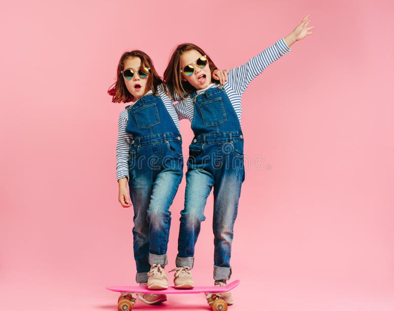 Stylish cute girls with skateboard stock photo Stylish cute girls with skateboard stock photo