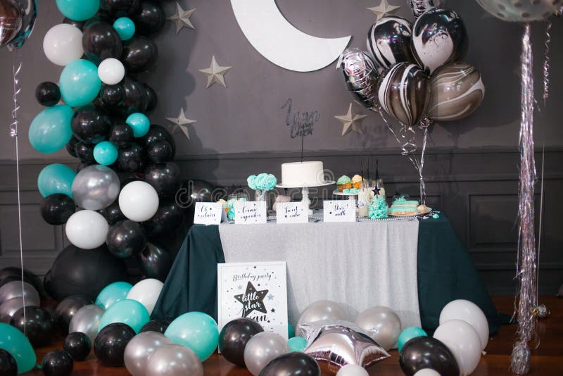 Stylish decorated children candy bar with balloons at the birthday party, holiday celebration concept with stars and moon