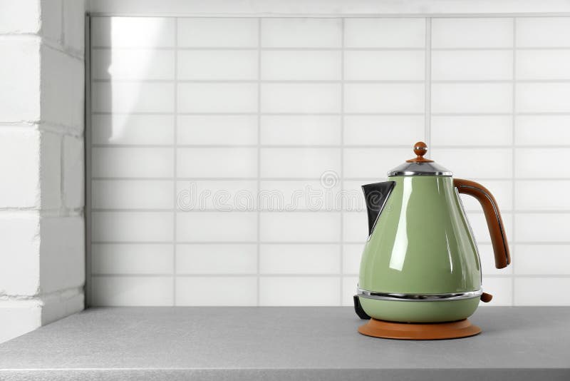 https://thumbs.dreamstime.com/b/stylish-electric-kettle-grey-table-against-wall-space-text-tea-preparation-white-159896335.jpg