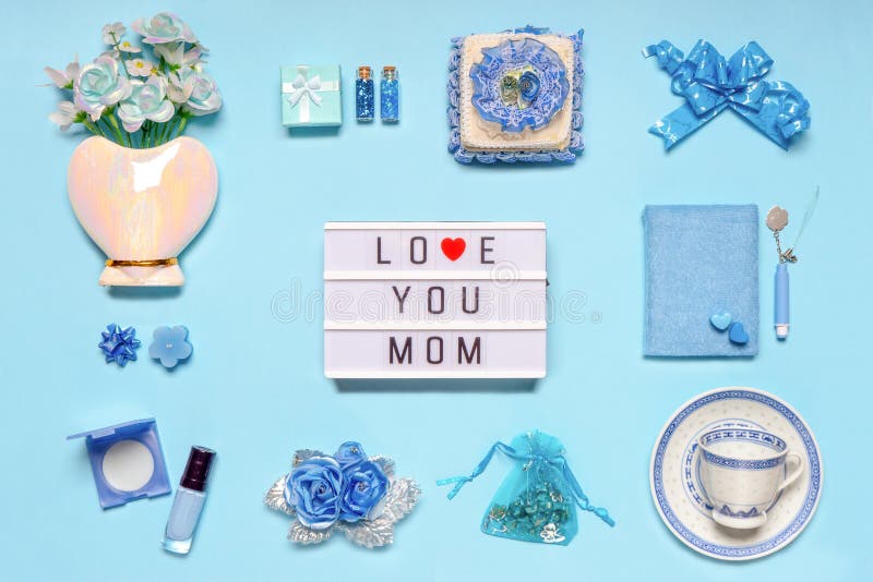 Stylish feminine accessories, flowers, cosmetics, gifts and decorative items in blue pastel colors on blue background. Text LOVE royalty free stock photography Stylish feminine accessories, flowers, cosmetics, gifts and decorative items in blue pastel colors on blue background. Text LOVE royalty free stock photography