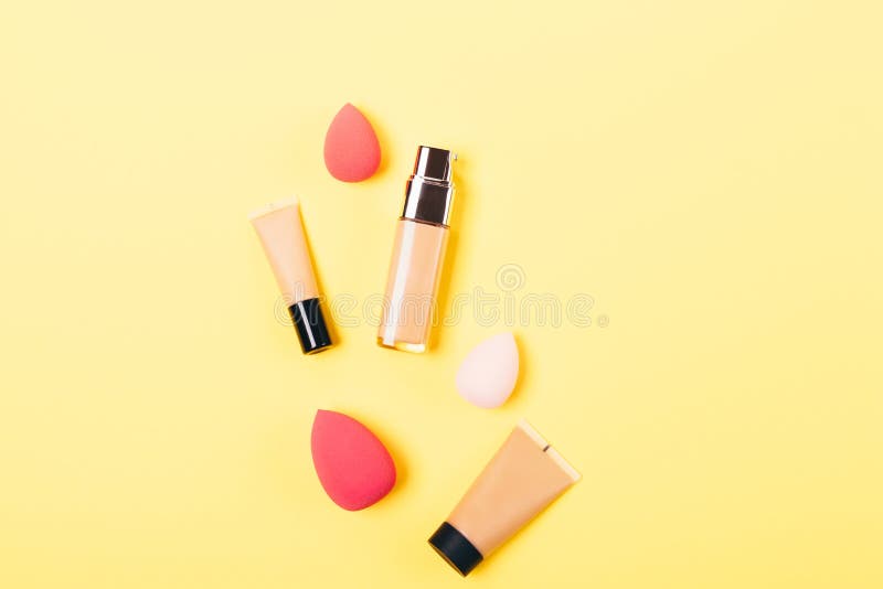 Stylish flat lay arrangement of bottles of makeup foundation