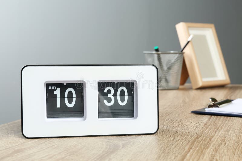 Stylish Flip Clock On Table In Office Space For Tex Stock Photo